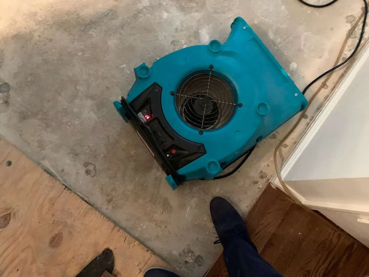 Air mover drying subfloor during Commercial Water Damage Restoration in Piedmont